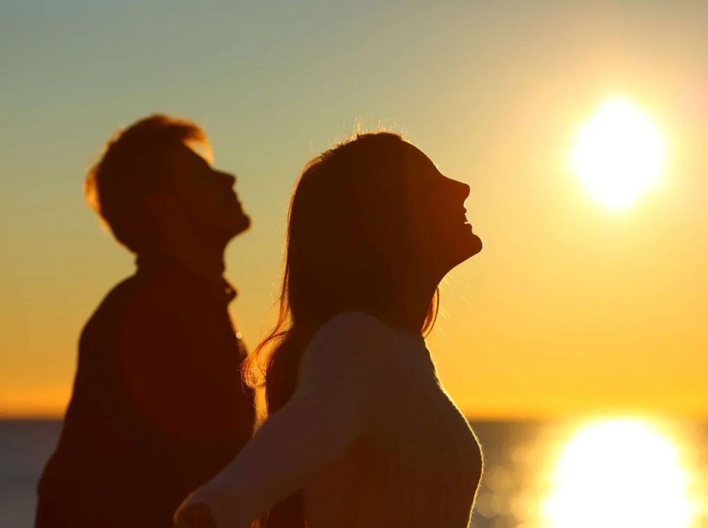 Two people relax by the water at sunset in Powell, WY, suggesting the balance and vitality that BHRT can support.