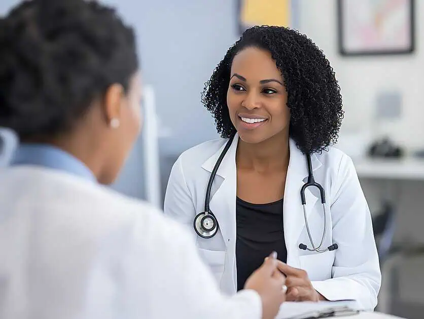 Female medical professional consults with patient in clinic, discussing IM Nutrient Therapy in Powell, WY.