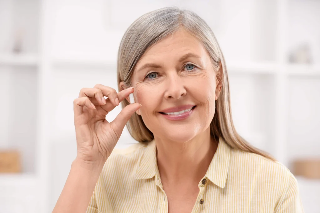 Woman holding hormone pellets in a clinic, highlighting Hormone Pellets in Powell, WY.