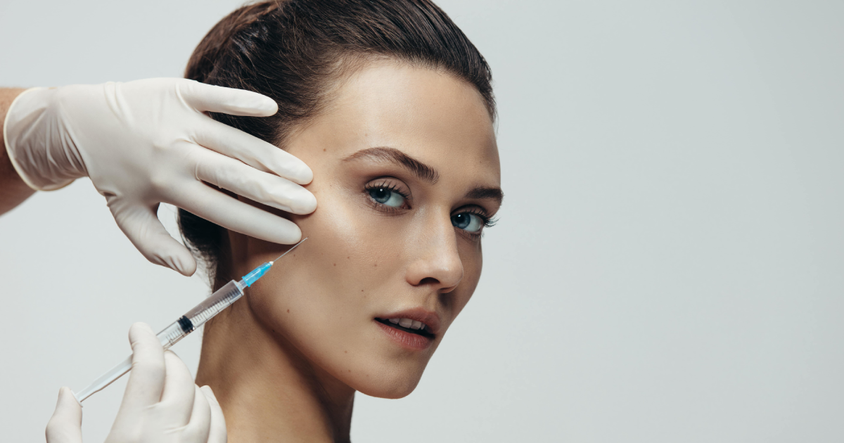 Woman receiving wrinkle treatments injection on cheek In Powell, WY