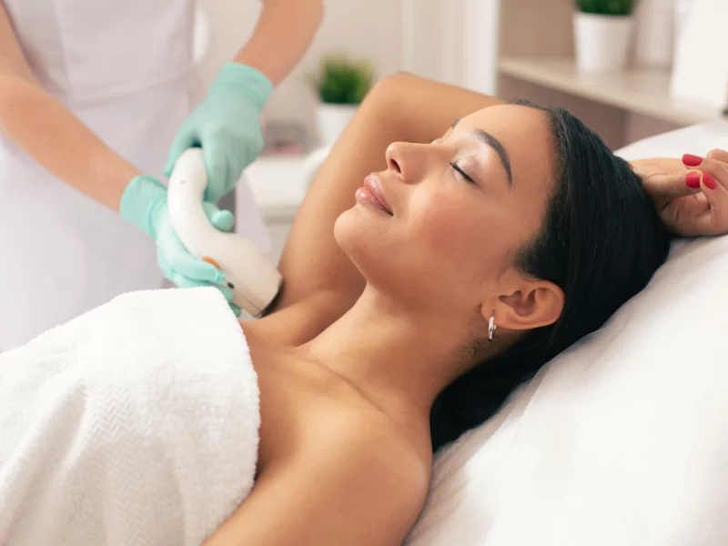 Patient receives comfortable underarm laser hair removal treatment from a medical professional in Powell, WY.